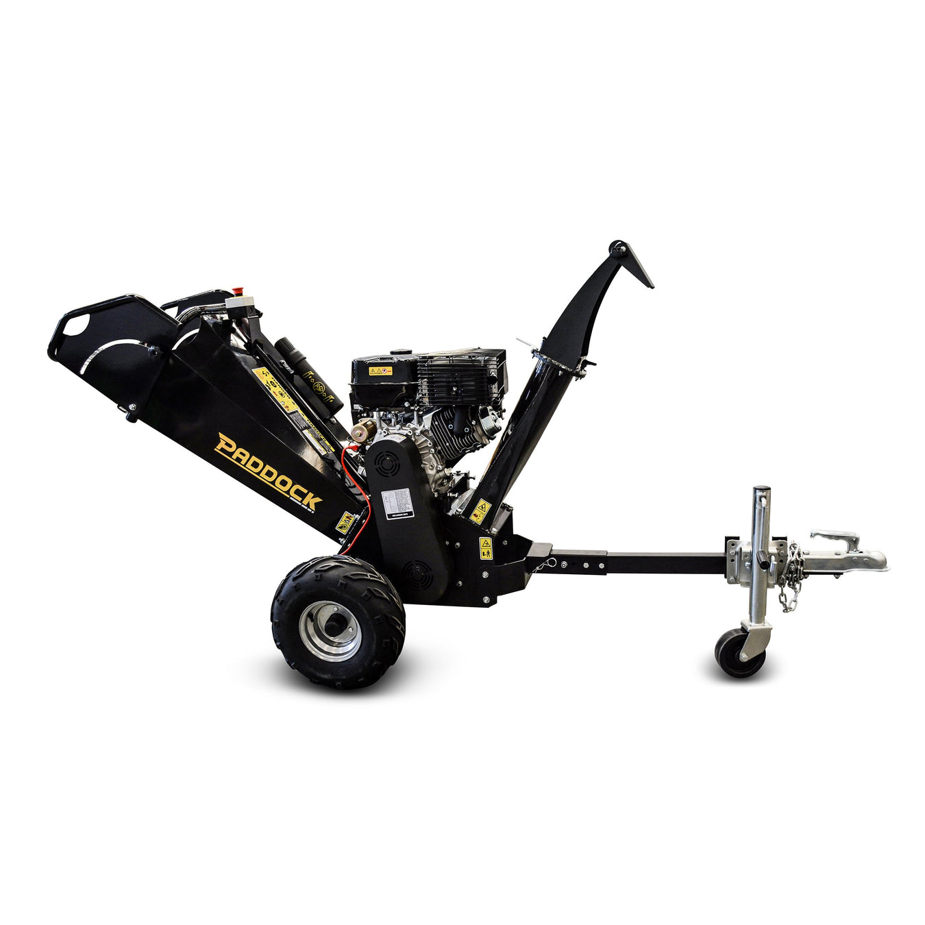 Black Paddock wood chipper machine with large wheels, an engine, and a tow hitch, designed for chipping branches and yard waste, isolated on a white background.