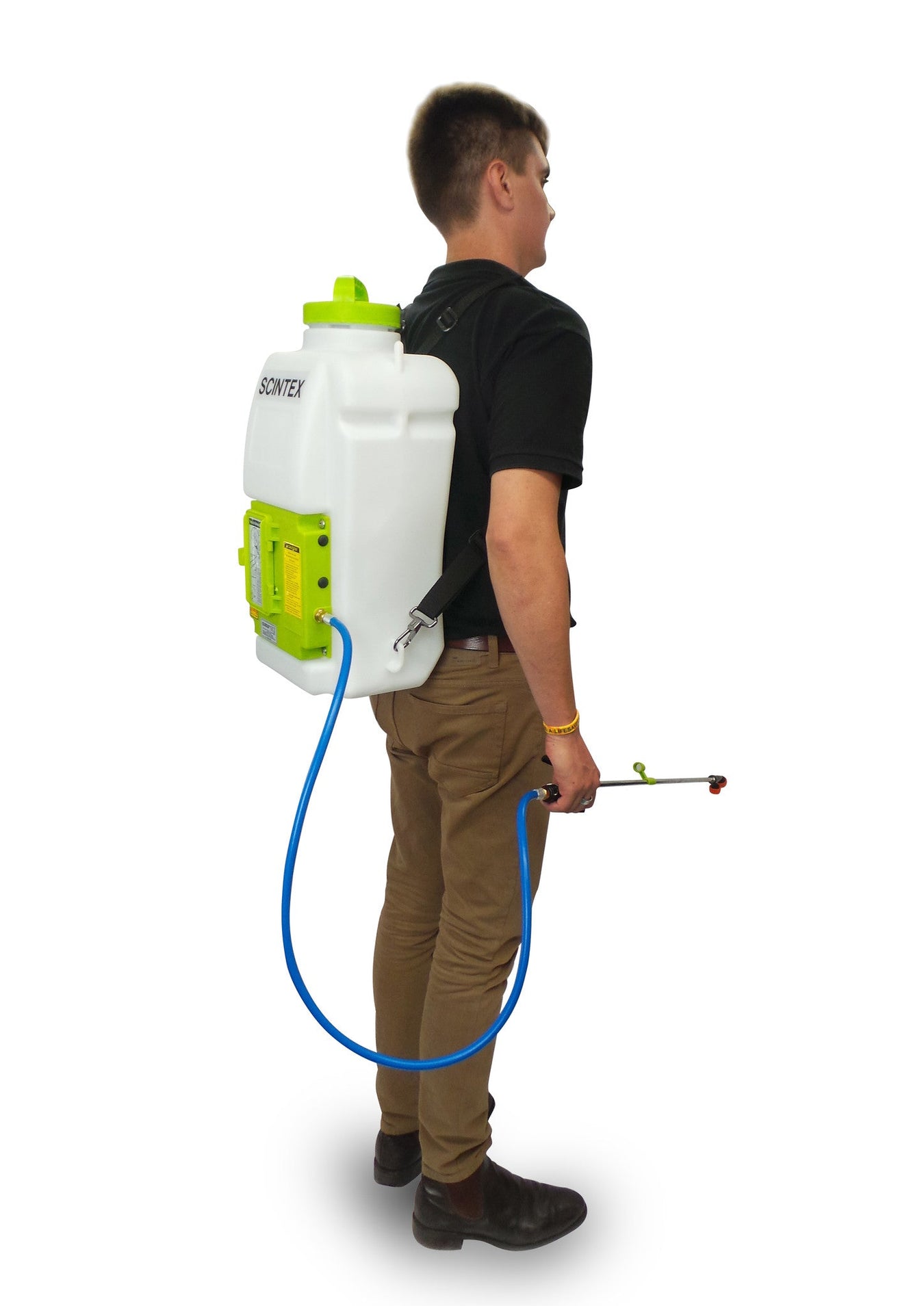 A person in a black shirt and brown pants wears a white and green backpack sprayer and holds a blue hose with a spray nozzle, standing against a white background.