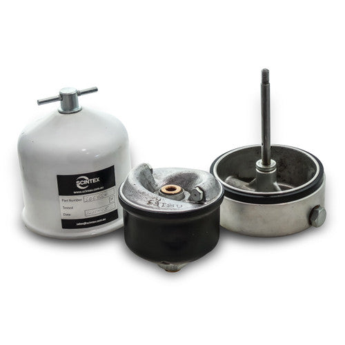 Three parts of a paint pressure pot system, including a white canister with a label, a black and metal lid with a center nozzle, and a metal chamber with a vertical rod.