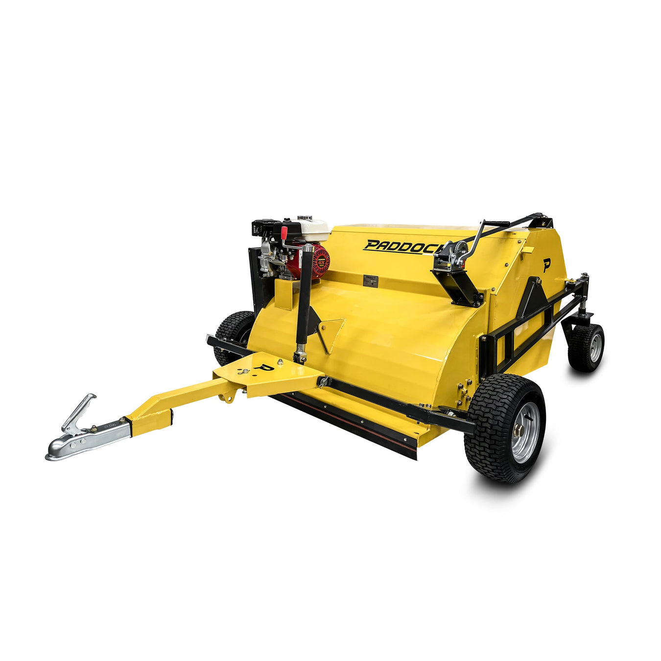 A yellow tow-behind paddock cleaner with black wheels and metal tow hitch, designed for collecting debris in fields or paddocks. The machine has a visible engine and sturdy build.