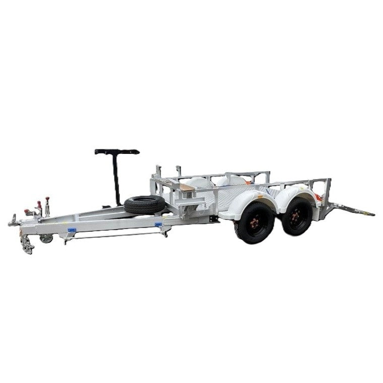 A dual-axle utility trailer with a metal frame, side rails, and a mounted spare tire at the front, isolated on a white background.