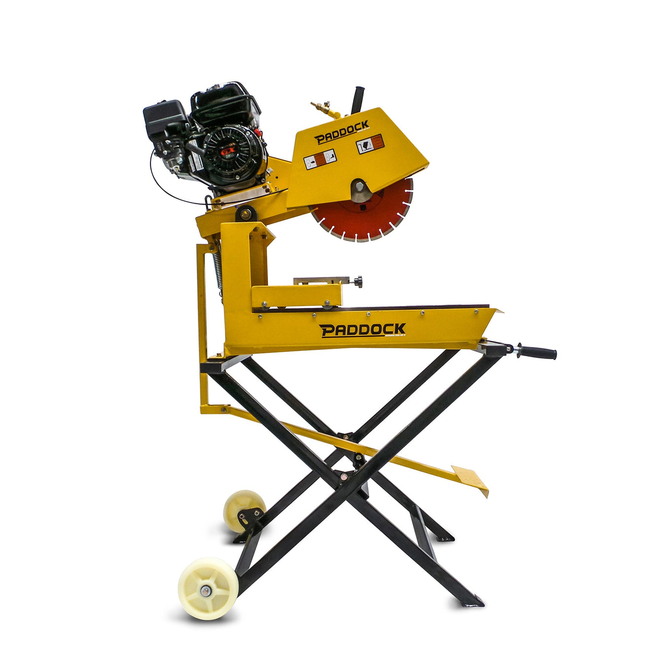 A yellow Paddock-branded concrete saw with a large red circular blade, mounted on a metal stand with wheels and a black engine on top.