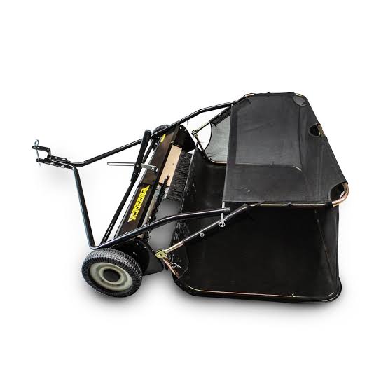 A black lawn sweeper with a mesh collection bag, two wheels, and a metal frame, designed for attaching to a vehicle for collecting grass, leaves, and debris from lawns.