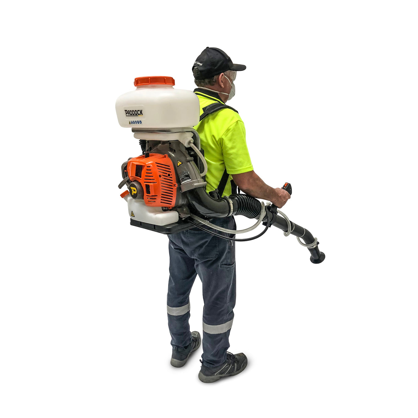 A man wearing a high-visibility shirt, cap, and face mask operates a large backpack sprayer with a hose, used for spraying chemicals or disinfectants.