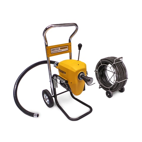 A yellow and silver electric drain cleaning machine with a black hose, mounted on a wheeled frame, next to a coiled metal cable reel on a small cart.