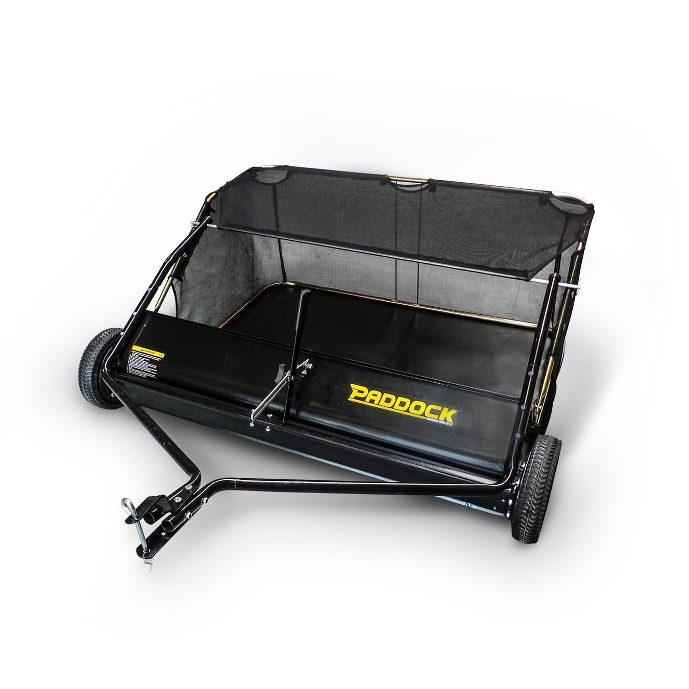 A black Paddock lawn sweeper with a mesh collection bag, two wheels, and a tow bar for attaching to a vehicle, shown on a white background.