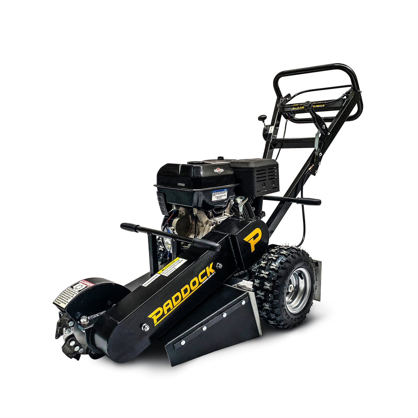A black Paddock-brand stump grinder with large treaded wheels, metal guards, and a visible engine, shown on a white background.