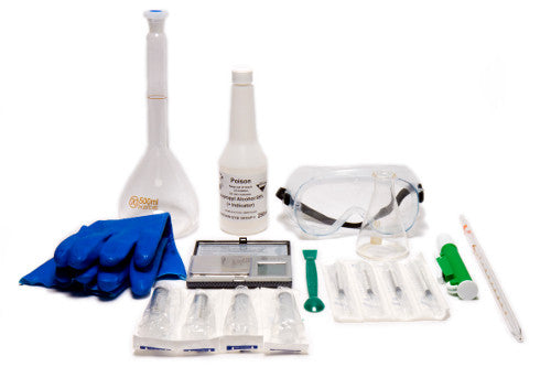 A chemistry lab kit with blue gloves, safety goggles, a flask, a bottle labeled Poison, syringes, a thermometer, and various small tools, all arranged on a white background.