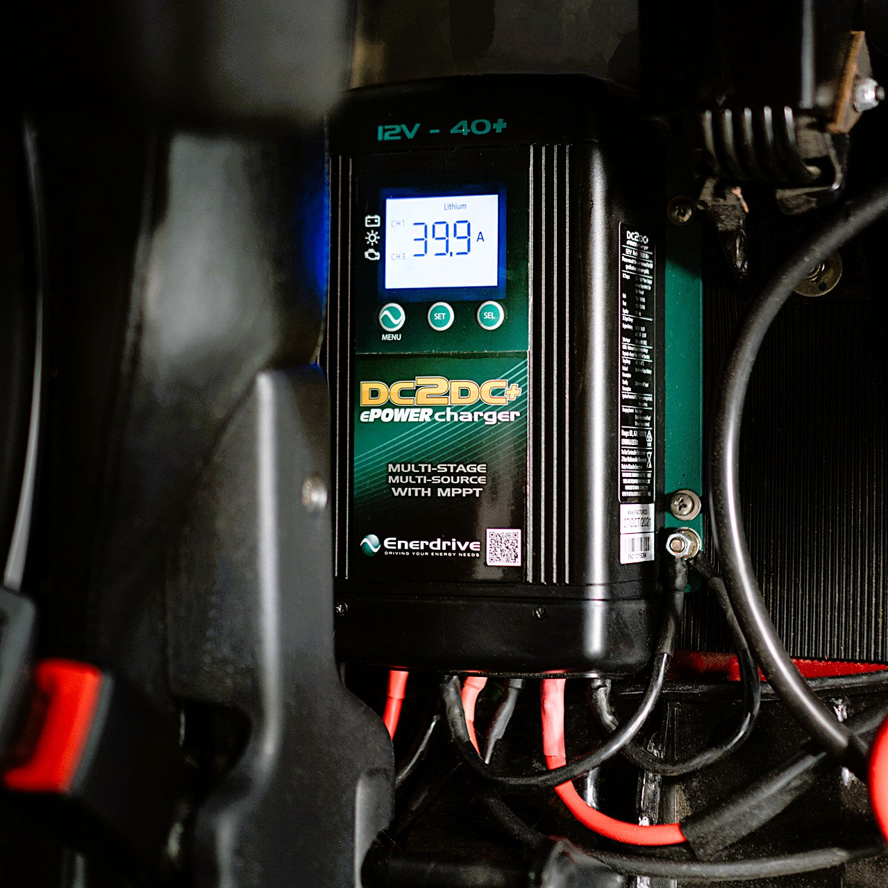 Close-up of an Enerdrive DC2DC Battery Charger / MPPT Reg showing 39.9 amps on its screen, with multiple red and black cables—this FREE SHIPPING 12V charger ensures efficient power management for your batteries.