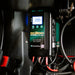 Close-up of an Enerdrive DC2DC Battery Charger / MPPT Reg showing 39.9 amps on its screen, with multiple red and black cables—this FREE SHIPPING 12V charger ensures efficient power management for your batteries.
