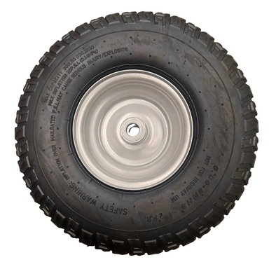 The Scintex Wheel - STBFS350, a black rubber replacement wheel with rugged tread and white metal rim, lies flat on concrete. Safety warnings and size info are printed on the sidewall, ideal for paddock fertiliser spreaders.