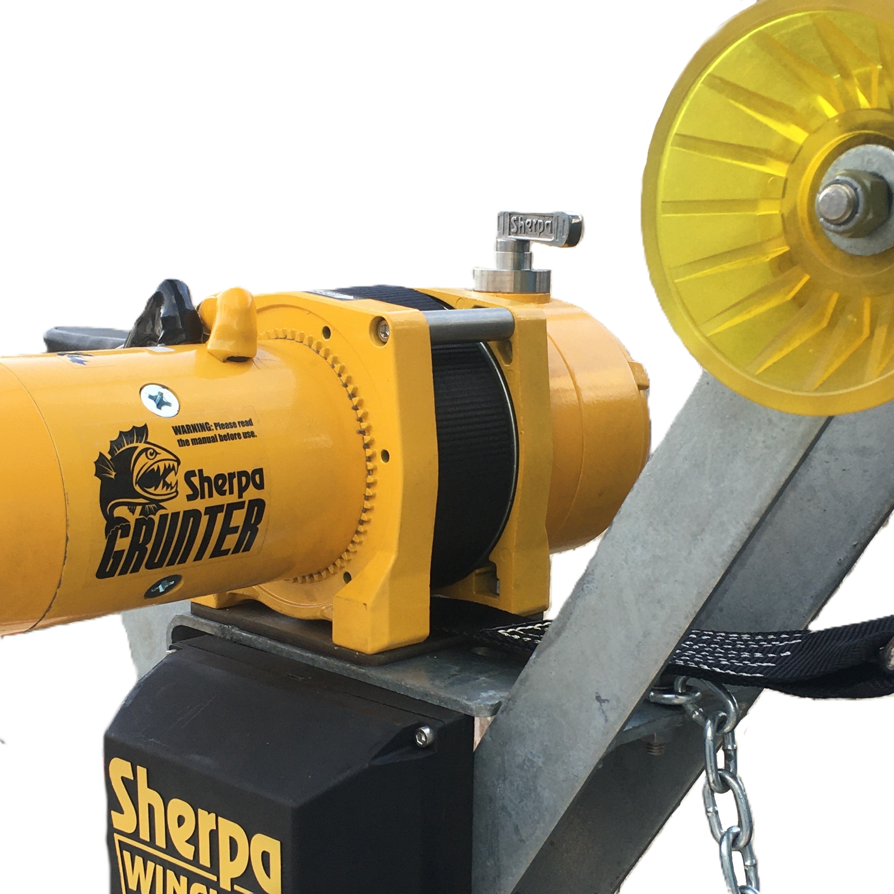 Close-up of a Sherpa 4x4 Black Edition ‘Grunter’ Electric Boat Trailer Winch mounted on a metal frame, featuring a yellow pulley and black strap. The Sherpa 4x4 logo and safety warnings are visible on the device, emphasizing its reliability as an electric boat trailer winch.