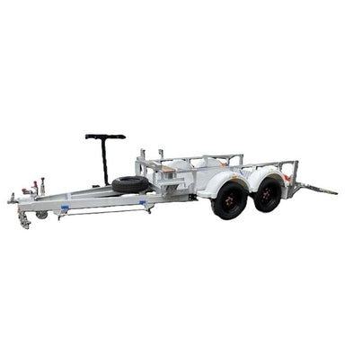 The Paddock Mini Loader & Excavator Alloy Equipment Trailer is a dual-axle utility trailer with a metal frame, two white wheel fenders, a front-mounted spare tire, and towing hitch—Australian-made in Brisbane.