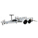 The Paddock Mini Loader & Excavator Alloy Equipment Trailer is a dual-axle utility trailer with a metal frame, two white wheel fenders, a front-mounted spare tire, and towing hitch—Australian-made in Brisbane.