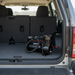 A Scintex On-board Air Compressor (51 L/min) is installed in the cargo area of an SUV with the rear hatch open, displaying the folded rear seats and spacious trunk.