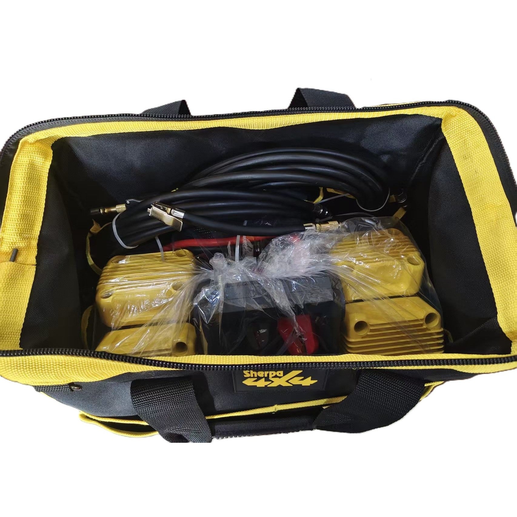 The Sherpa 4x4 'BIG V4' Air Compressor (400 L/min) & Digital Tyre Deflator Bundle includes two yellow compressors, black hoses, accessories for tyre inflation, all in a black and yellow bag.