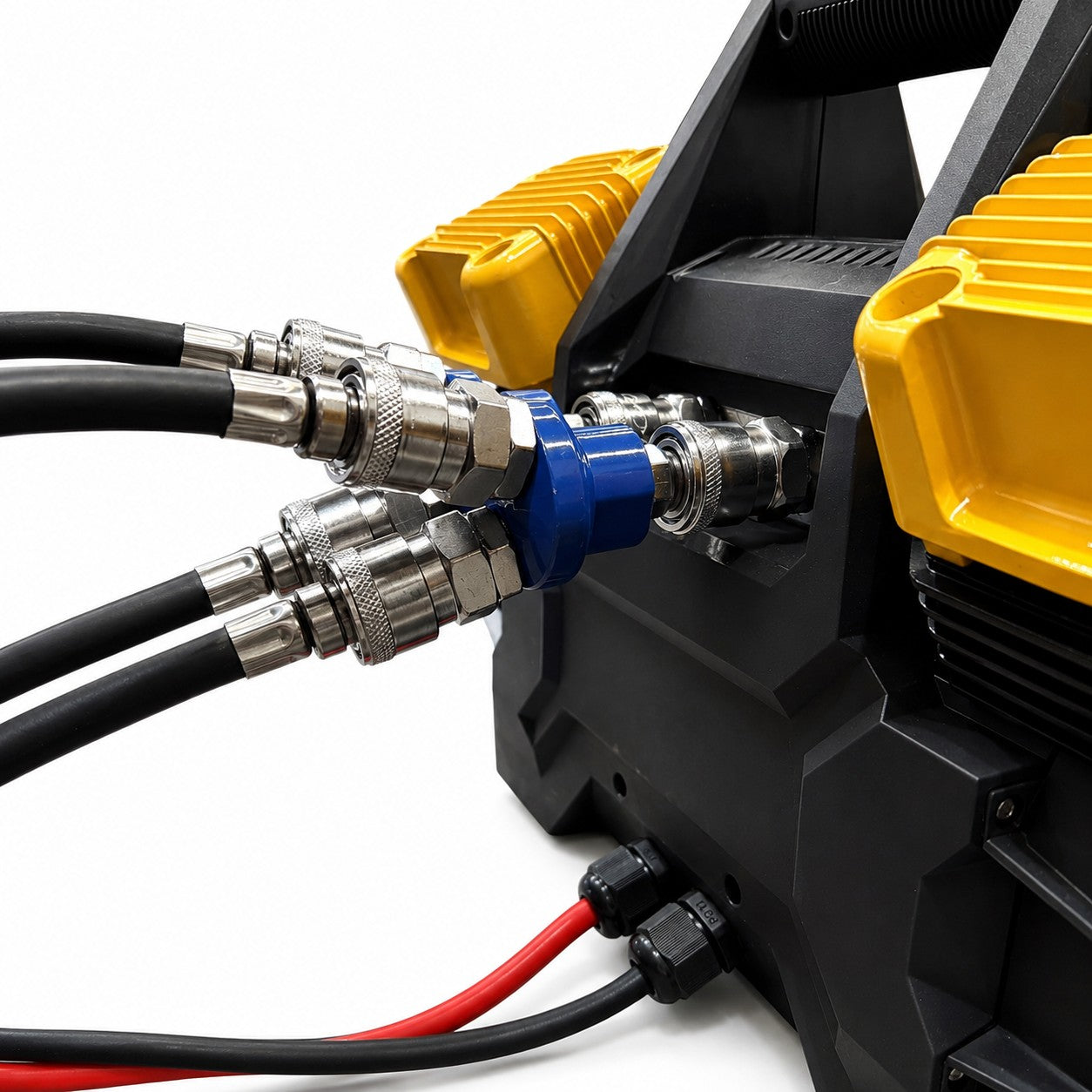 Close-up of black and red cables connected to a black and yellow mechanical device, likely a component of the Sherpa 4x4 ‘BIG V4’ Quad-Air Upgrade Kit – 4-Tyre Inflation System, featuring metal connectors and a blue fitting at the center. The out-of-focus background draws attention to the detailed parts of this Sherpa 4x4 upgrade kit.