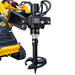 A close-up of a yellow construction machine fitted with a Paddock 350mm (14″) Stump Planer Attachment by Paddock, mounted on a black hydraulic auger. This setup is designed for efficient stump removal and can be easily swapped with other attachments, such as spiral drill bits for drilling holes in the ground. Several hoses are connected to the auger’s motor, highlighting its heavy-duty hydraulic operation.
