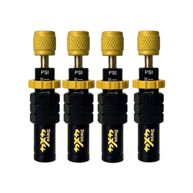 Four Sherpa 4x4 Tyre Deflators—black and gold, each showing "PSI" and 15–30 range—are lined up on a white background, offering fast, accurate air-down for any off-road trip. Set of four by Sherpa 4x4.