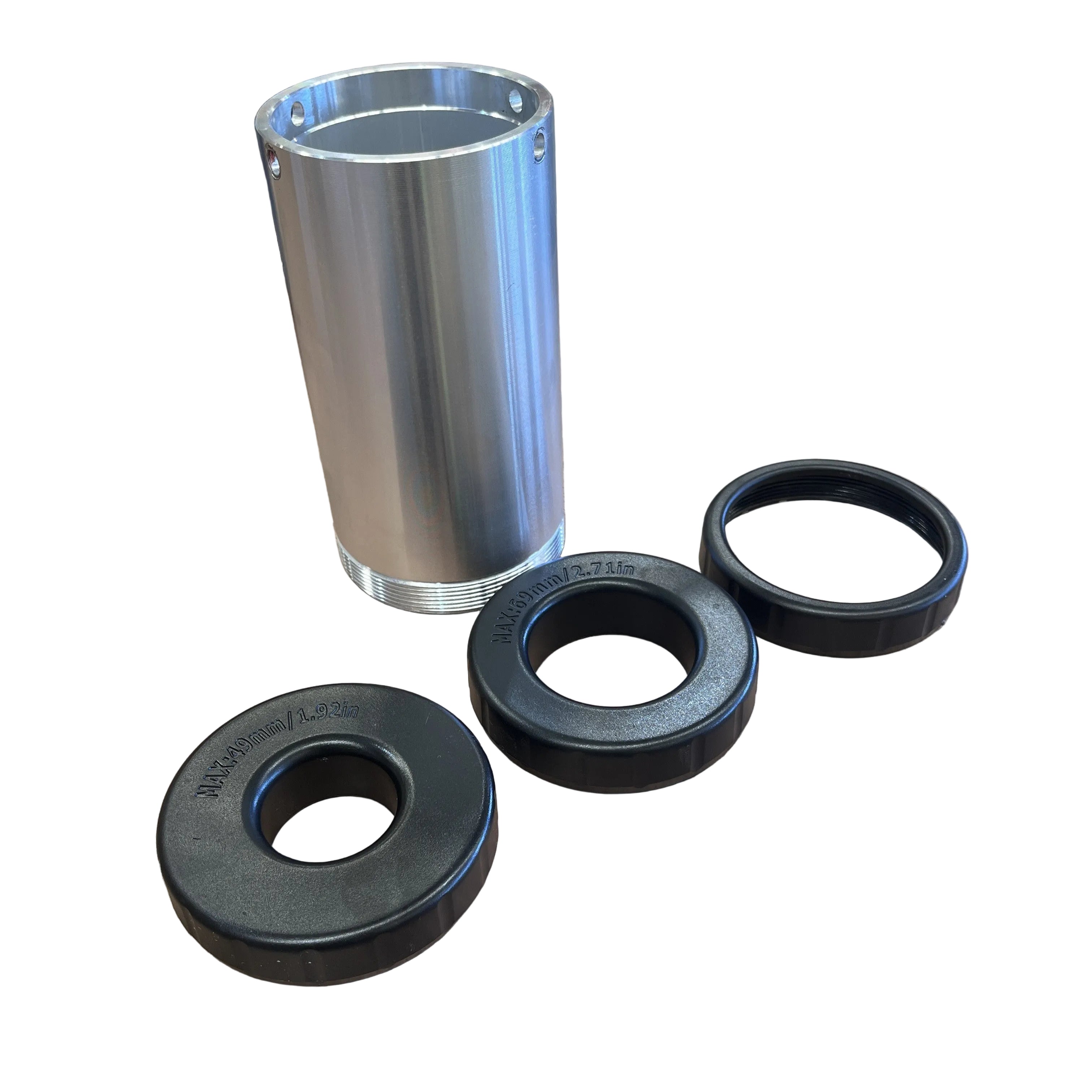 The Paddock Motorised Post Driver by Paddock, a cylindrical metal tool with a threaded bottom, is shown alongside three black plastic rings of different sizes on a white background.