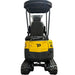 A Paddock Excavator Series 17 with 6 Attachments Bundle by Paddock, in yellow and black, is parked indoors on a concrete floor facing the camera, with industrial shelves stocked in the background.