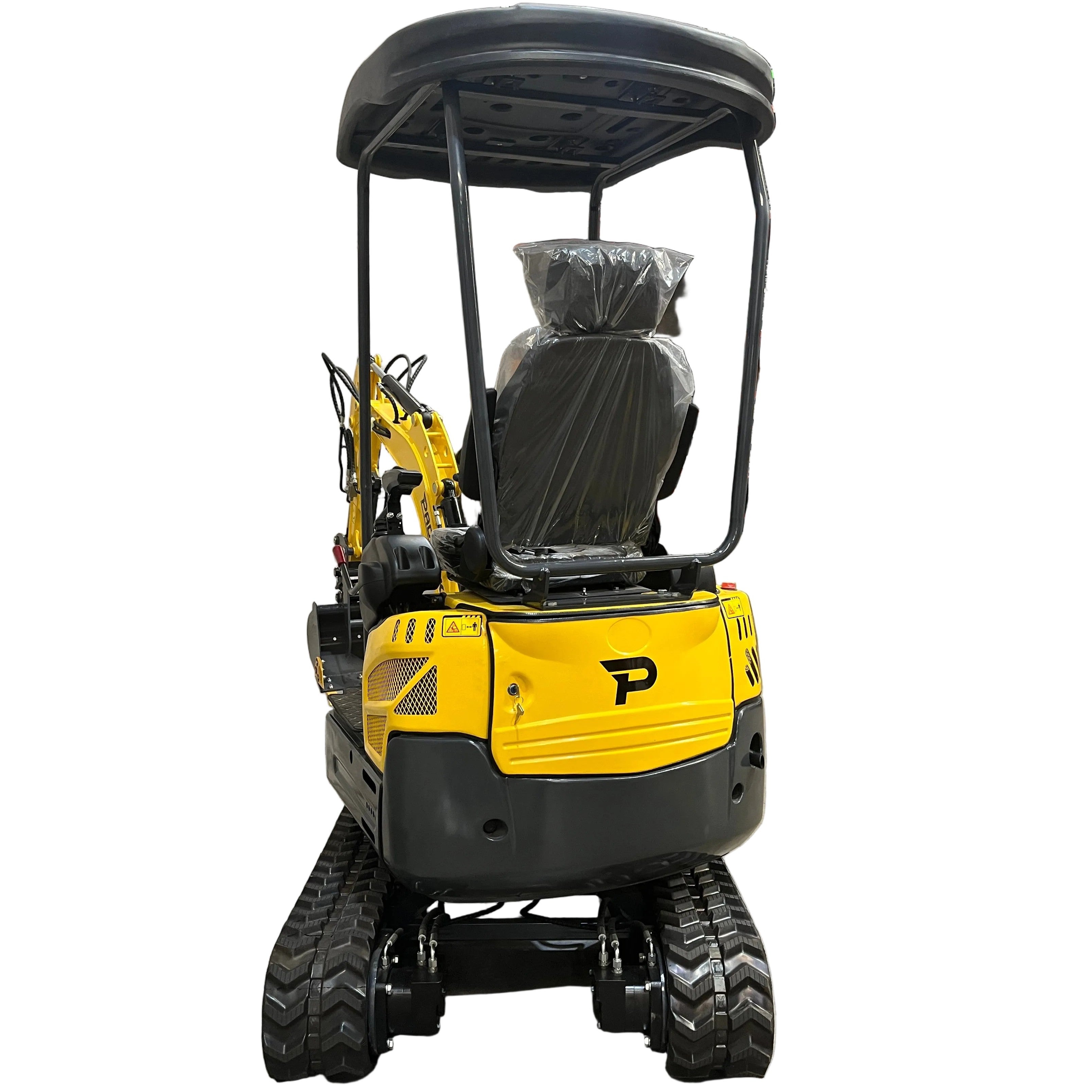 A Paddock Excavator Series 17 in yellow with black tracks is parked indoors on concrete, surrounded by shelving and pallets. The Paddock bundle includes 6 attachments visible nearby.