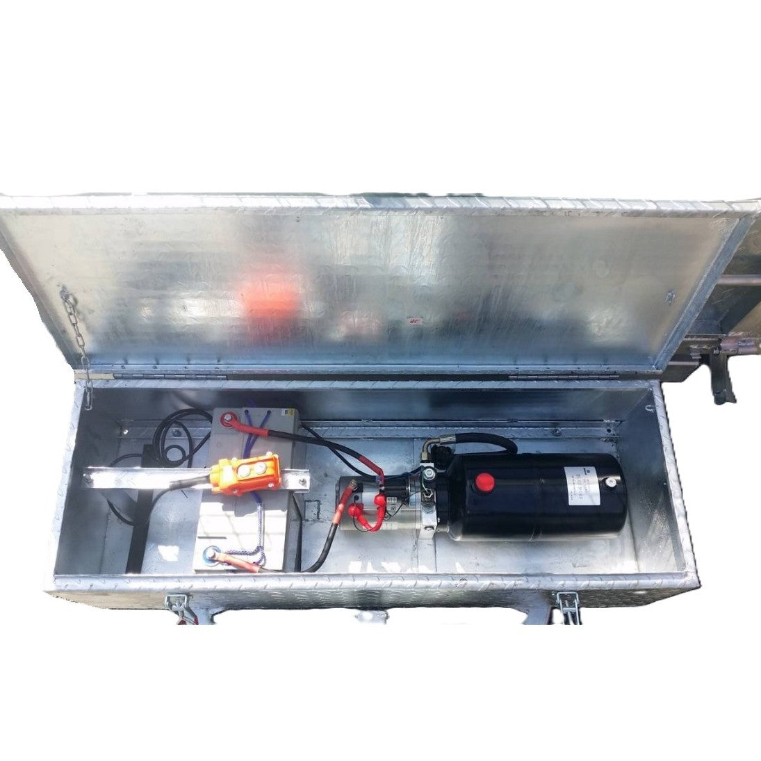 The Paddock Mini Loader & Excavator Alloy Equipment Trailers feature a metal box with an open lid displaying electrical parts such as a black cylindrical motor, control switches, wiring, and battery pack—perfect for Australian heavy duty machinery.