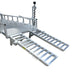 The Paddock Mini Loader & Excavator Alloy Equipment Trailers by Paddock feature silver metal ramps with dual grated tracks, attached to a trailer platform—ideal for loading heavy equipment and vehicles.
