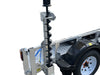 A yellow Paddock mini skid steer loader sits on a Paddock Mini Loader & Excavator Alloy Equipment Trailer, with an auger attachment secured upright by the trailer’s side and visible warning labels on the custom alloy frame.