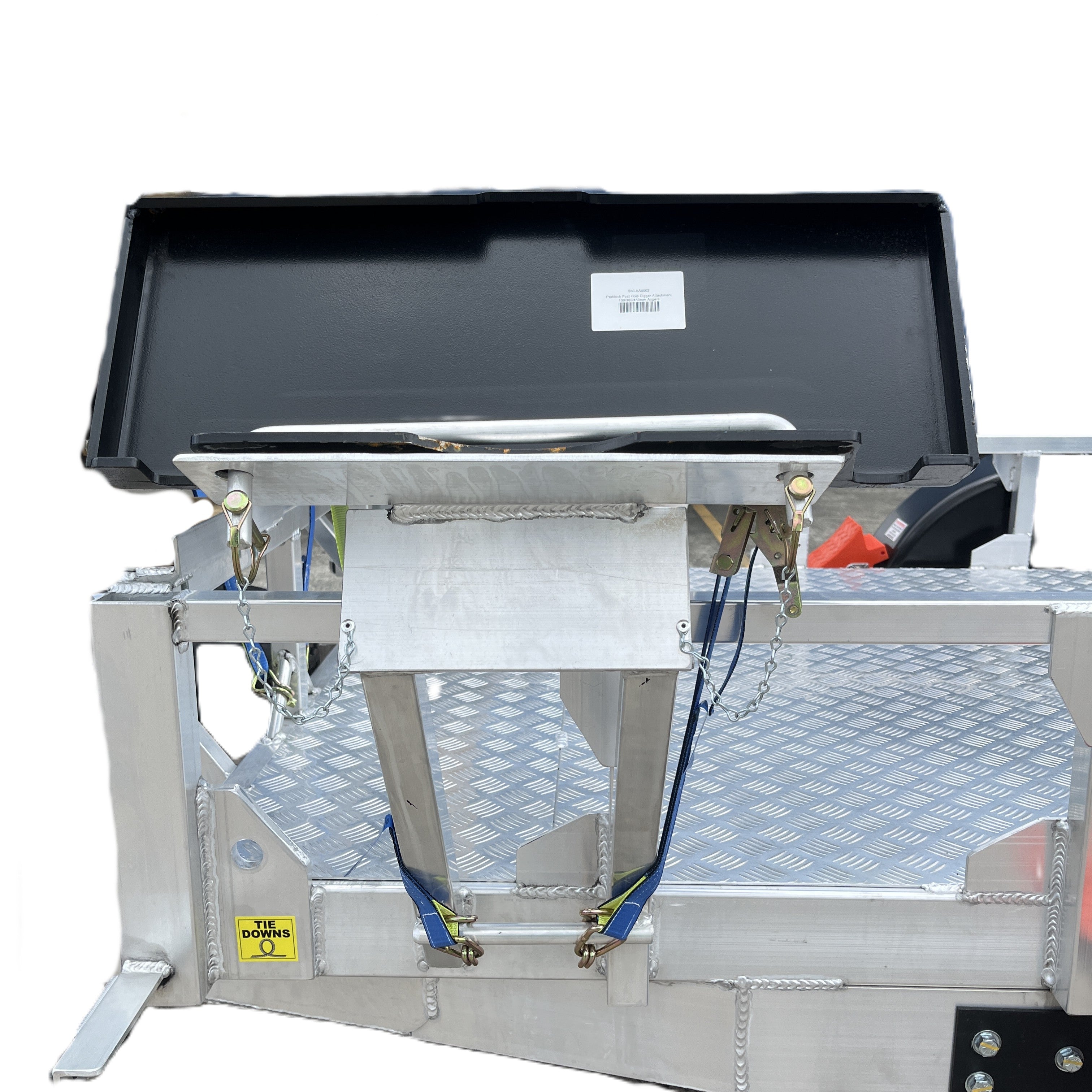 The Paddock Mini Loader Trailer Power Head Mount & 3x Auger Holder features a textured metal platform, black lid, blue/yellow straps, and safety labels—perfect for securely transporting heavy-duty machinery augers on trailers.