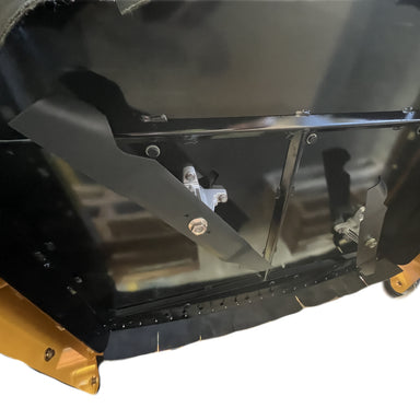 Close-up of a black metal panel with bolts and brackets, featuring the Paddock RC Mower Finishing Blade Set by Paddock, with gold-colored edges at the bottom, shown against a white background.