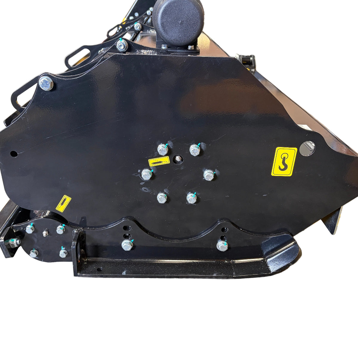 A close-up view of a black metal industrial machine part with bolts and yellow caution labels, set against a white background—this component is essential for the reliable performance of the Paddock™ PTO Offset Verge Flail Mower by Paddock.