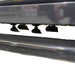 Close-up of the Paddock™ PTO Offset Verge Flail Mower by Paddock, showing its row of flat, paddle-like black blades suspended from a dark metal frame, designed for heavy-duty mowing applications, set against a white background.