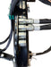 Close-up of four metal hydraulic hose fittings attached to a black mechanical component, with hoses encased in black protective sleeves, set against a white background—highlighting the robust construction characteristic of the Paddock™ PTO Offset Verge Flail Mower by Paddock, engineered for reliable performance with your tractor mower.