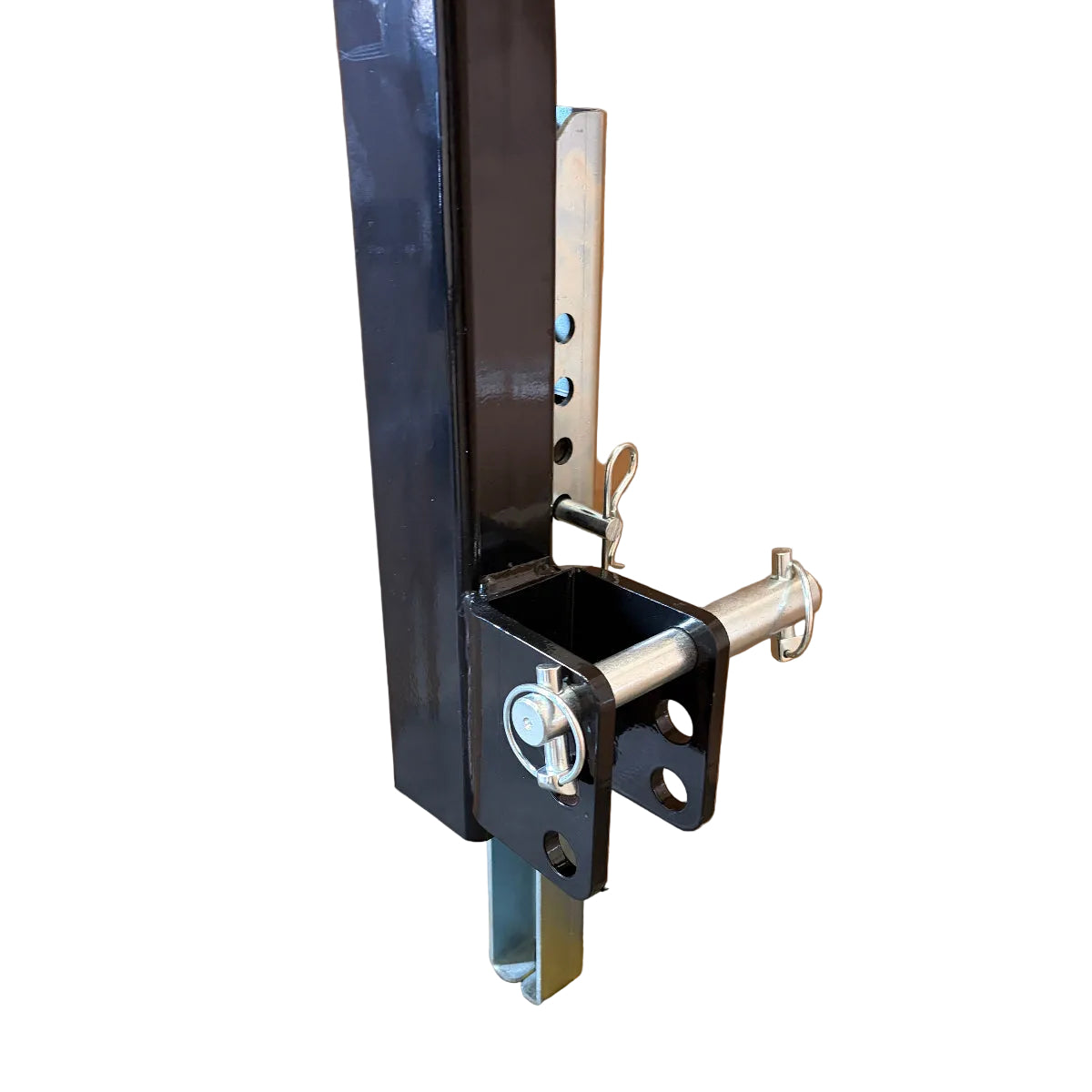 Close-up of a black metal adjustable hitch or mounting bracket with a silver pin, attached to a vertical metal post featuring multiple holes for height adjustment—designed for securely attaching heavy-duty implements like the Paddock™ PTO Offset Verge Flail Mower by Paddock, or other compatible tractor mowers. Isolated on a white background.