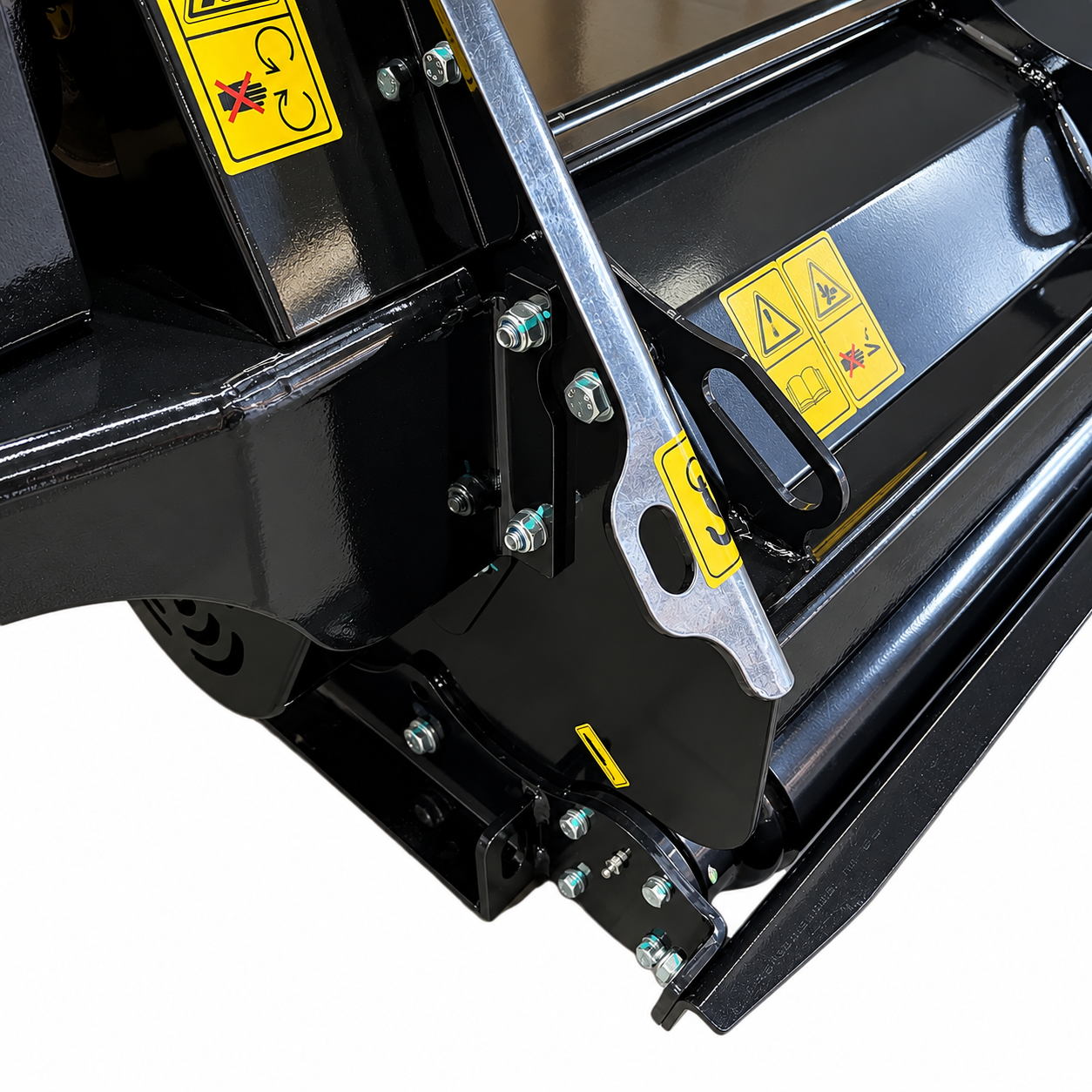 Close-up of a black industrial machine part from the Paddock™ PTO Offset Verge Flail Mower by Paddock, featuring bolts and yellow caution labels with warning symbols, photographed on a white background.