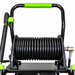 Paddock™ 3,200 PSI Cold Water Pressure Washer with Hose Reel featuring a coiled black hose and a green-handled frame.
