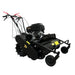 The Paddock Walk Behind Flail Mower 12HP – 900mm by Paddock features large rear wheels, red handles, and a powerful engine. Positioned on a concrete floor against a gray wall, it’s ideal for heavy-duty vegetation control.