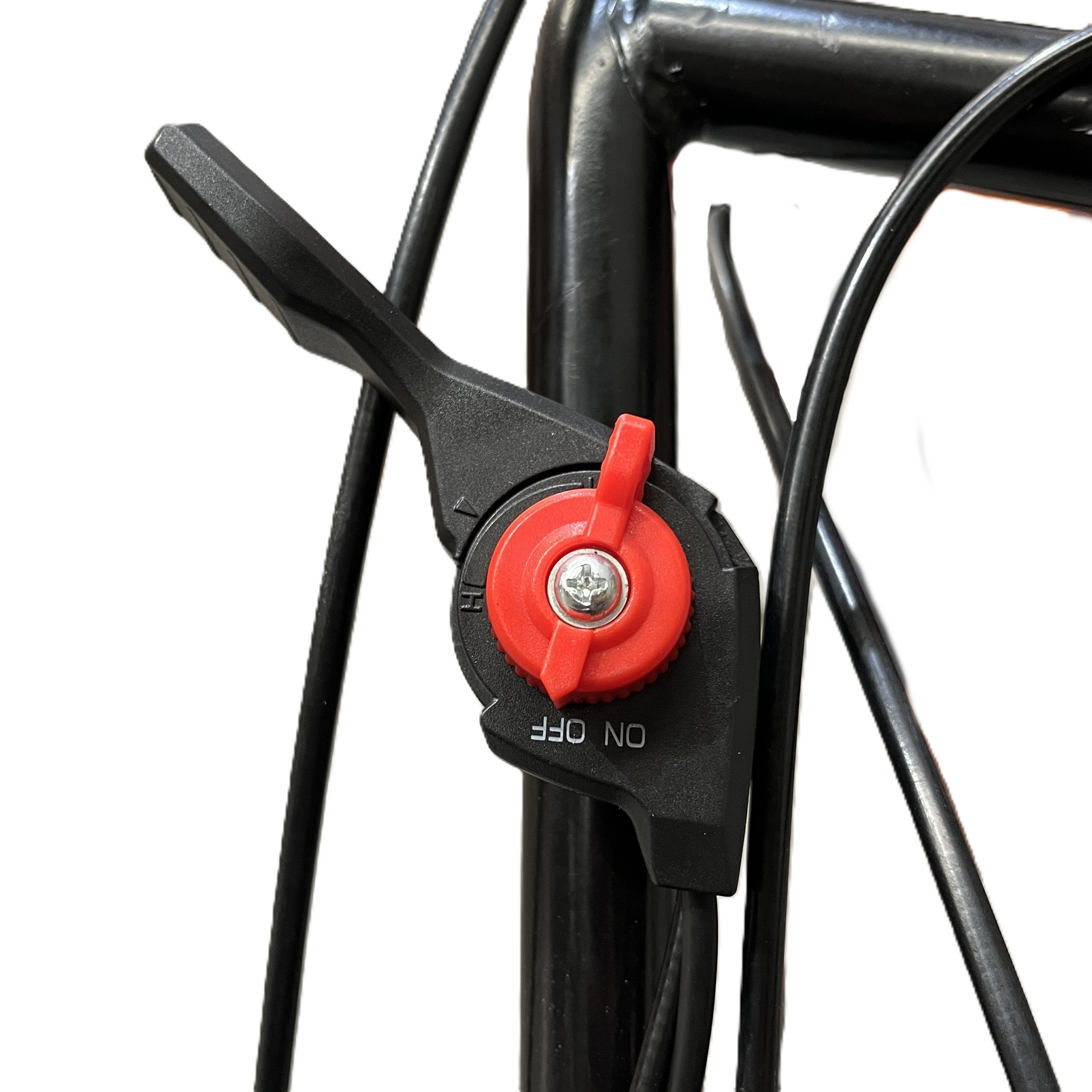 A close-up of the black and red ON/OFF switch on a Paddock Walk Behind Flail Mower 12HP - 900mm, with cables attached to the black metal frame and a person in shorts blurred in the background.