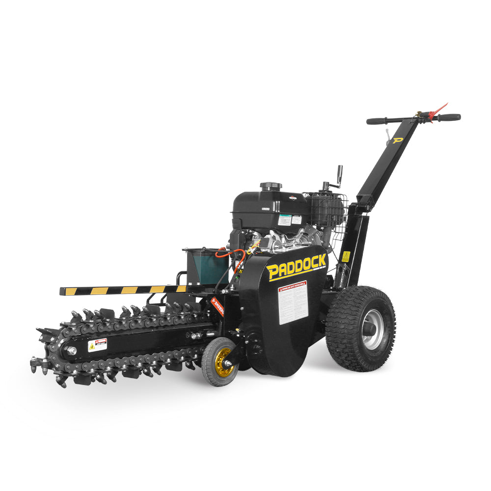 The Paddock Walk Behind Trencher with Guide Wheel is a portable black trencher by Paddock, featuring large rear wheels, a front digging chain, handlebar controls, and is ideal for easily cutting narrow trenches in the ground.