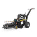 The Paddock Walk Behind Trencher with Guide Wheel is a portable black trencher by Paddock, featuring large rear wheels, a front digging chain, handlebar controls, and is ideal for easily cutting narrow trenches in the ground.