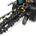 Close-up view of the Paddock Walk Behind Trencher with Guide Wheel, featuring a rotating chain with digging teeth, yellow and black safety stripes, a support wheel, and powered by a reliable Briggs & Stratton engine. Brand: Paddock.