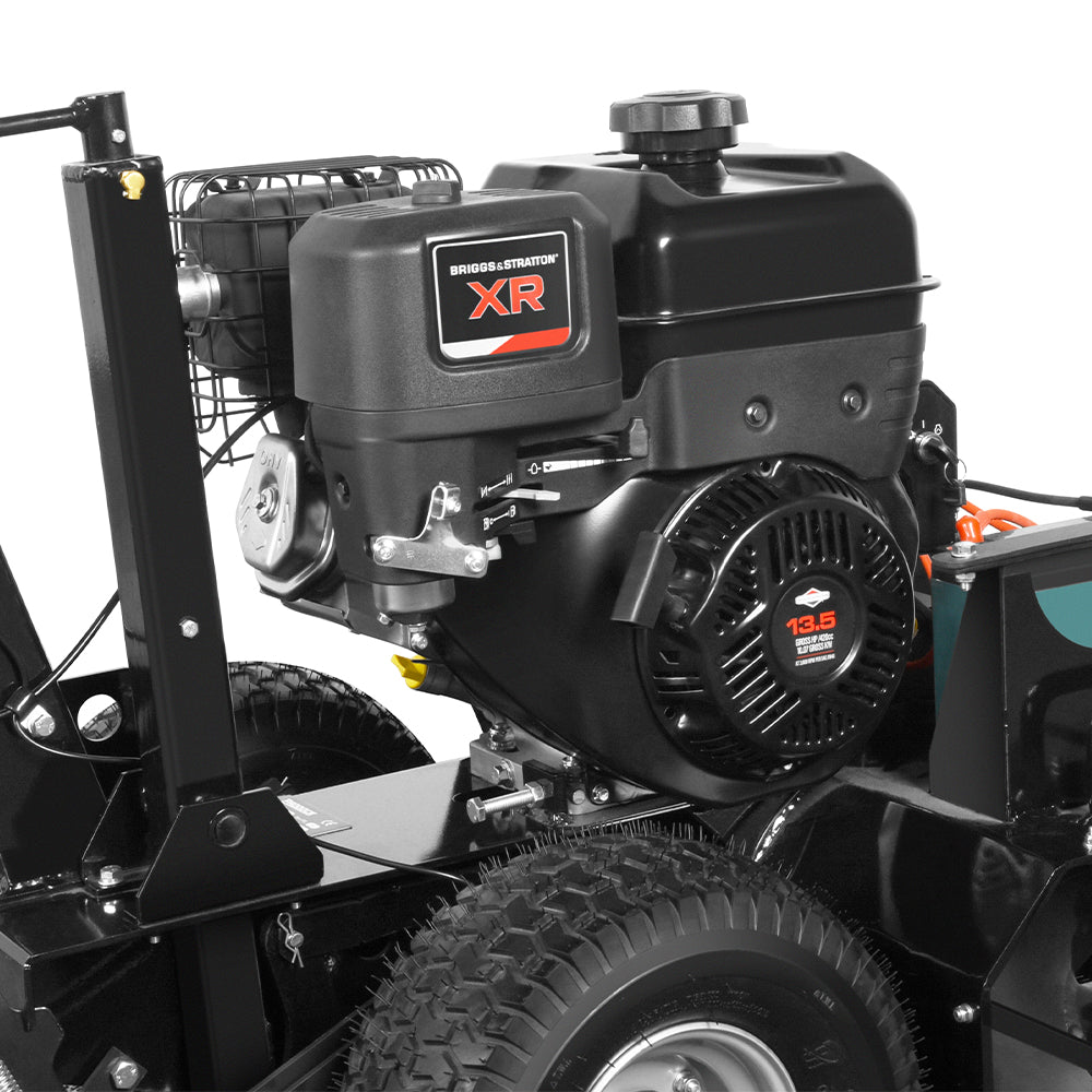 Close-up view of a Paddock Walk Behind Trencher with Guide Wheel, featuring a Briggs & Stratton XR 13.5 HP engine, visible engine components, tires, and part of the sturdy black machine frame.
