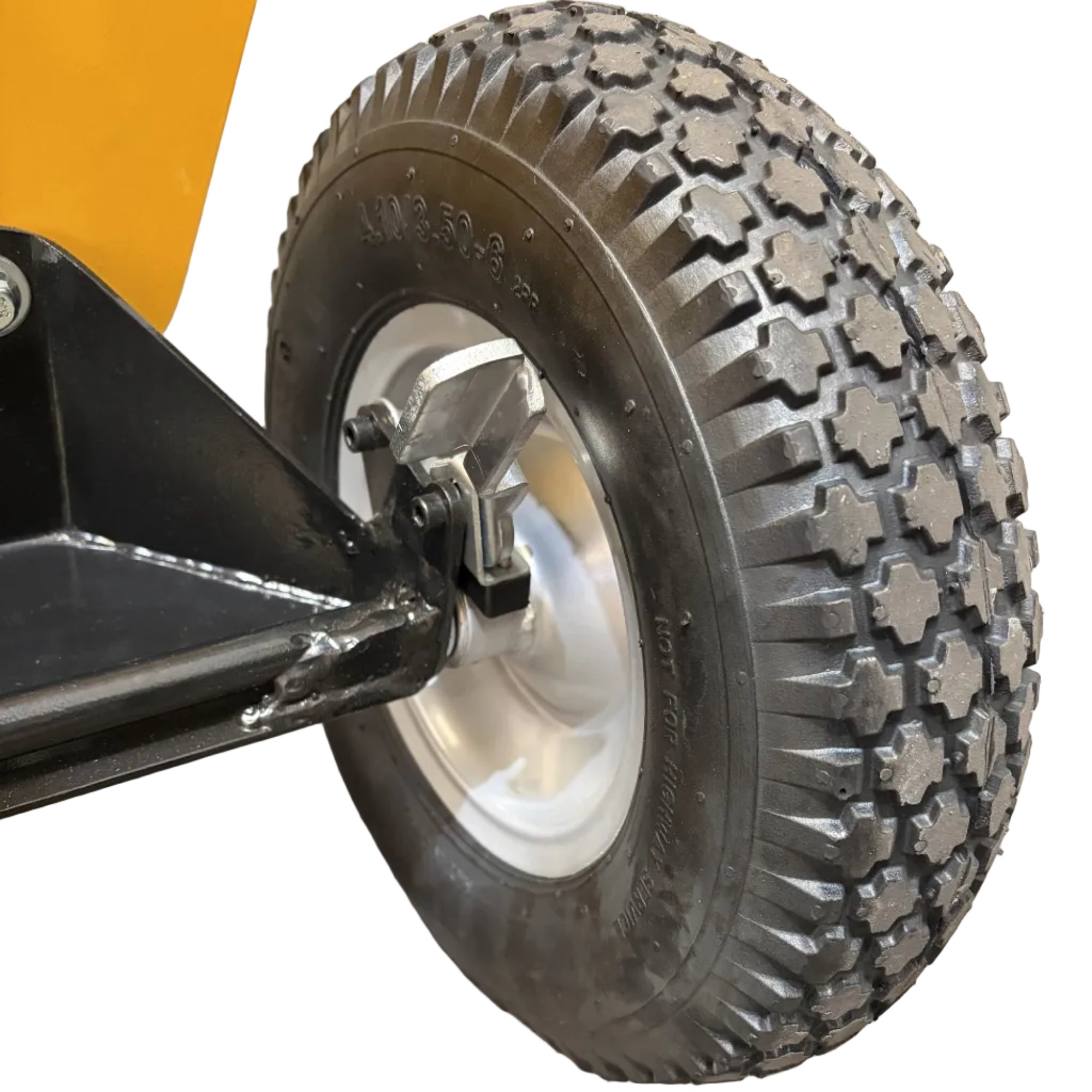 Heavy-duty treaded rubber wheel attached to the metal frame of a Paddock™ Wood Chipper Shredder 75mm.