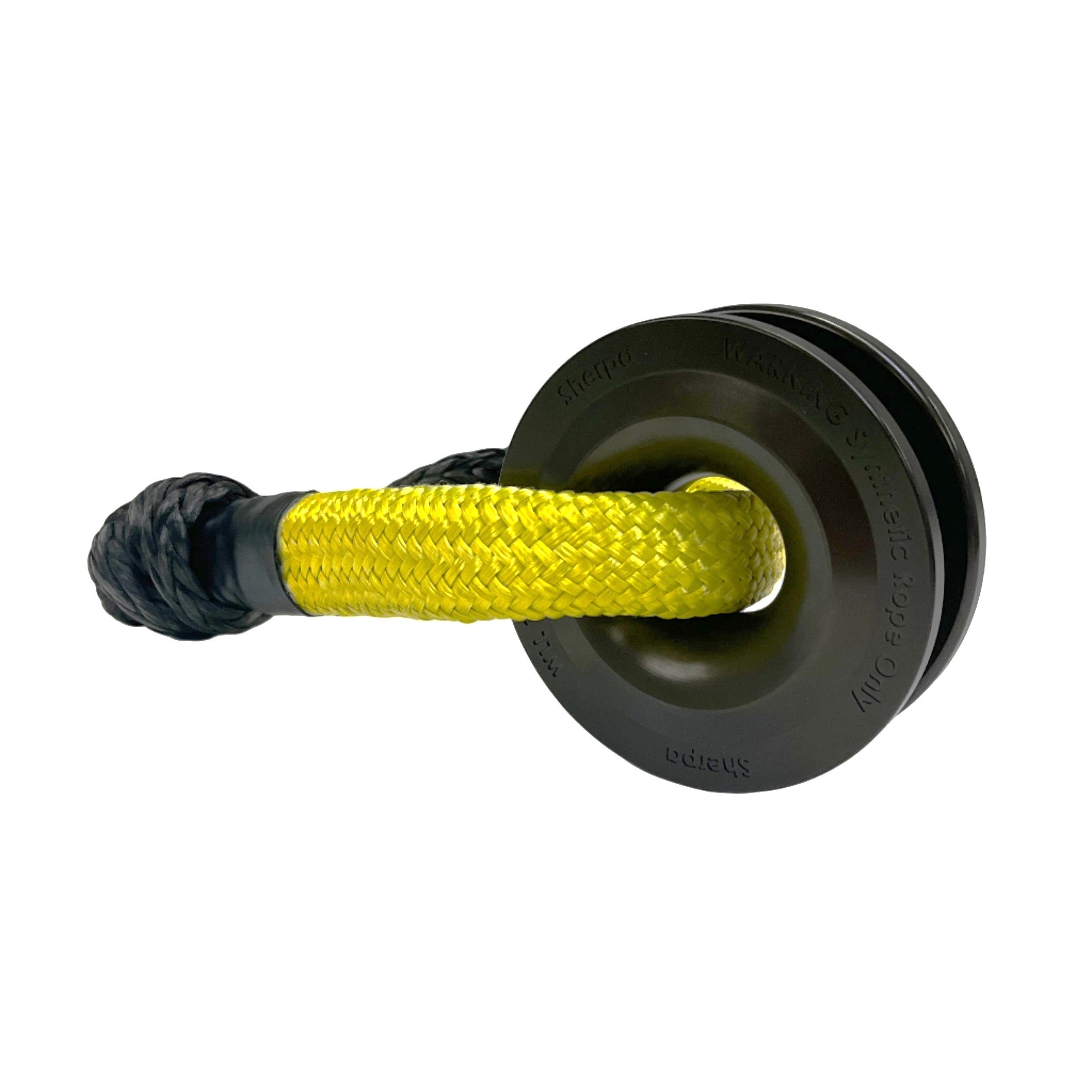 A close-up of a yellow synthetic rope looped through the black Sherpa 4x4 Recovery Ring, with a gray rope splice—ideal for those seeking strength and durability from the Sherpa 4x4 Recovery Ring & Soft Shackle Bundle.