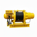 The Sherpa 4x4 3-Phase Electric Motor Winch is yellow, features a black cable on the drum, is mounted on a metal base, and includes a wired control pendant.