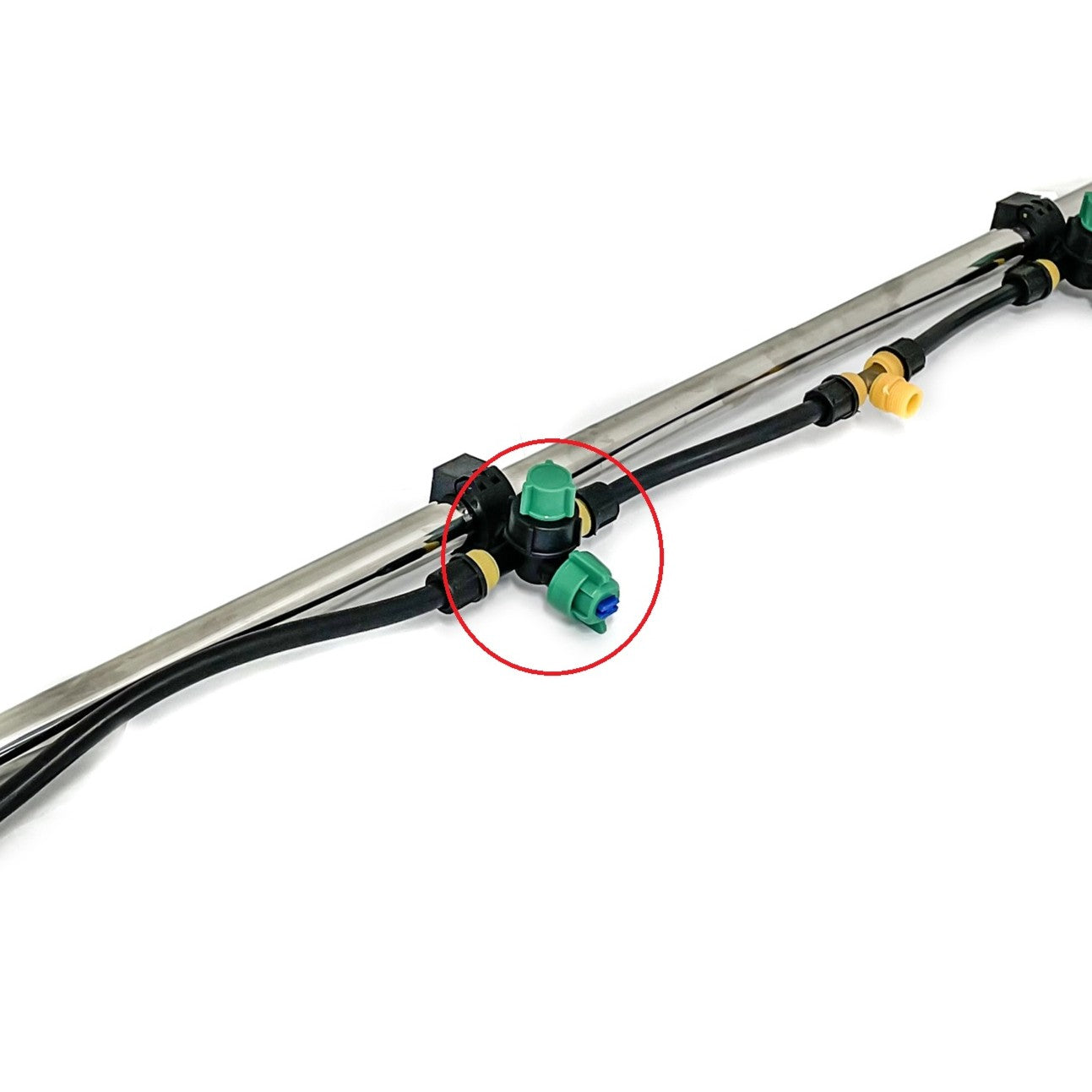 Close-up of a metal pipe with black tubing and plastic connectors; a green and blue Scintex Paddock Spray Boom Tee Fitting Assembly is highlighted in red, showing its use for efficient spray distribution on Paddock sprayers.