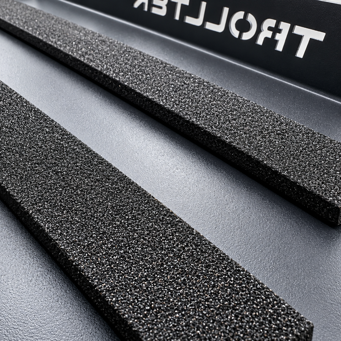Two parallel rectangular foam strips resting on a Trolltek™ Aluminium Battery Tray.