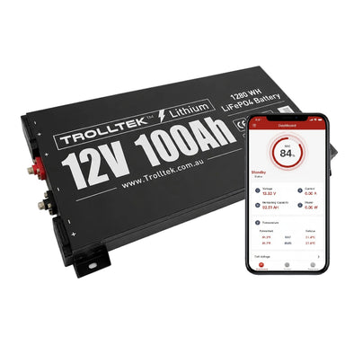 A black 12V Trolltek™ LiFePO4 Super Slimline Lithium Battery with Bluetooth app, featuring a display panel and terminals, is shown next to a smartphone displaying the battery monitoring app screen from Trolltek. This highlights its advanced battery management system from Trolltek for enhanced performance and long cycle life.
