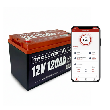 A Trolltek 12V Trolltek™ LiFePO4 Lithium Battery with Bluetooth is shown beside a smartphone displaying the battery status, including charge, voltage, current, capacity, power, and temperature via a monitoring app.